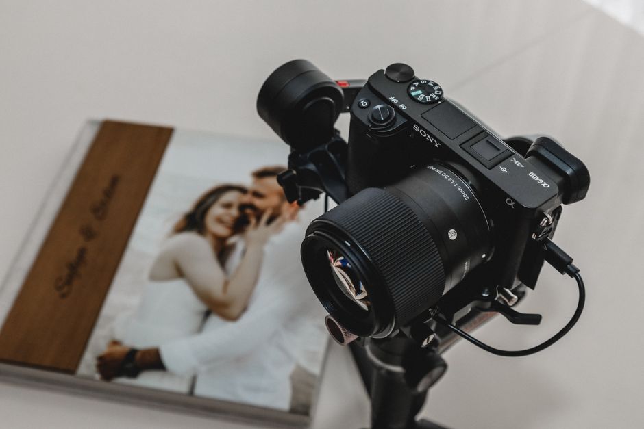 A professional wedding photographer adjusting their camera
